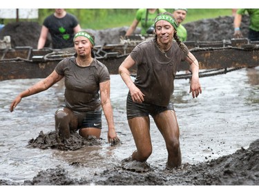 Hannah Newman (L) and Meghan Newman (R) head to the finish as the Mud Hero Ottawa 2016 continued on Sunday at Commando Paintball located east of Ottawa.