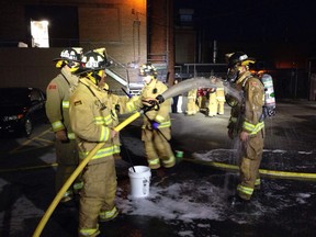 Ottawa firefighters undergo decontamination procedures following the fire at the Ottawa Bank Note Co.