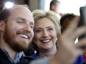 Democratic presidential candidate Hillary Clinton takes a selfie during a stop at Uprising Muffin Company, Friday, June 10, 2016, in Washington.