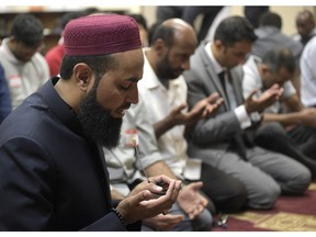 Imam Azhar Subedar, left, speaks during a special prayer that included non-Muslims at the American Muslim Community Center Monday in Longwood, Fla., after the mass shootings at the Pulse Orlando nightclub.