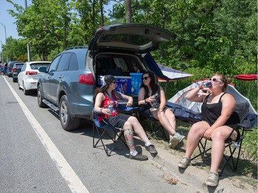 Jay Hodgson (from Left) Allix Wallace, and Jayme Wallace from Kitchener set up their tent along HWY 148 with loads of others as the annual Amnesia Rockfest invades the village of Montebello in Quebec, about an hour away from Ottawa and Montreal.