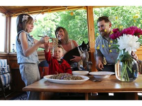 Jen and Steve Wall, parents of Kinley and Anderson, enjoy a meal at home in their airy screened-in porch.