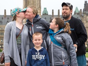 Jenn Miller's daughter, Haylee, 13, gives her a kiss after she arrives in Ottawa having walked from London to raise awareness for diabetes. With them are Miller's son, Grayson, 5, and daughter Lilee, 11, and the children's father, Tim Lentz.