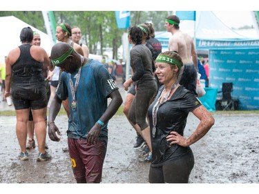 Jessica Trotto (R) at the finish line with other competitors as the Mud Hero Ottawa 2016 continued on Sunday at Commando Paintball located east of Ottawa.