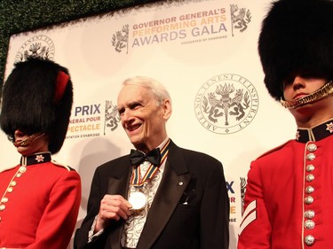 John D. McKellar, recipient of the Ramon John Hnatyshyn Award for Voluntarism in the Performing Arts, shows his medallion to the crowd on the red carpet as he arrives to the National Arts Centre on Saturday, June 11, 2016, for the Governor General's Performing Arts Awards Gala.