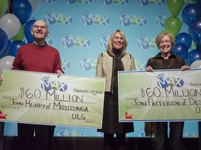 John Henry of Mississauga and Joan Patterson, of Desboro, Ont., right, receive cheques for $60 million at a ceremony in Toronto on Feb. 24. It was the largest lottery payout in one day for the OLG.