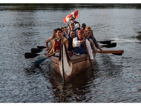 A morning paddle for the PM: Justin Trudeau joins others in a voyageur canoe on the Ottawa River following the National Aboriginal Day Sunrise Ceremony in Gatineau on Tuesday.