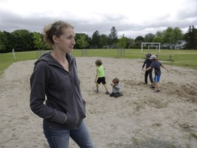 Karen Adelberg and her four boys in the sand pit that used to contain a  play structure at Leslie Park Public School. From left, Marcelo, who is in Grade 3, Lucas, in Grade 1, and Ethan, in Grade 4, with Logan, age 3, in mom's lap.