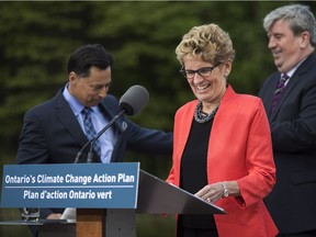 Ontario Premier Kathleen Wynne arrives to make an announcement on climate change policy with Ontario Minister of Economic Development, Employment and Infrastructure Brad Duguid, left, Ontario Minister of the Environment and Climate Change Glen Murray, right, at Evergreen Brickworks in Toronto, Wednesday June 8, 2016.