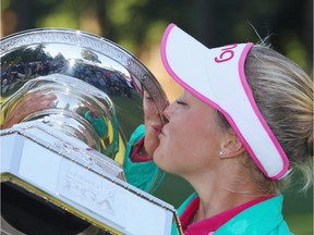 Brooke Henderson kisses the trophy after winning the KPMG Women's PGA Championship at the Sahalee Country Club on June 12, 2016 in Sammamish, Wash.