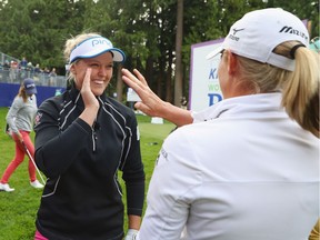 Brooke Henderson of Canada (L) is greeted by Stacy Lewis after a shot during the LPGA Tour Player Showcase prior to the start of the KPMG Women's PGA Championship at the Sahalee Country Club on June 8, 2016 in Sammamish, Washington.