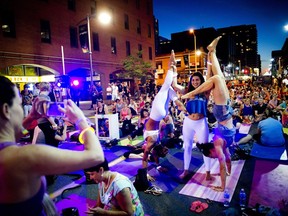 L-R Marie-Julie Côté, Sara Campbell and Andrée-Anne Ouellet played around before a yoga class on Bank Street during Glowfair Festival Friday June 17, 2016.   Ashley Fraser/Postmedia
