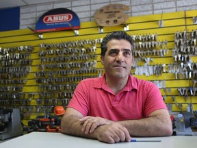 Michel Kiwan, owner of First Choice Locksmith, poses for a photo in his store in Ottawa. Michel's van fell into a giant sinkhole on Rideau Street Wednesday. (Tony Caldwell/Postmedia)