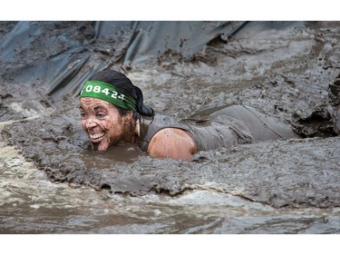 Marcia George makes her way through an obstacle as the Mud Hero Ottawa 2016 continued on Sunday at Commando Paintball located east of Ottawa.