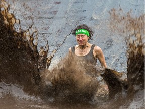 Marie-France Marcoux makes a splash down in a mud pit as the Mud Hero Ottawa 2016 continued on Sunday at Commando Paintball located east of Ottawa.