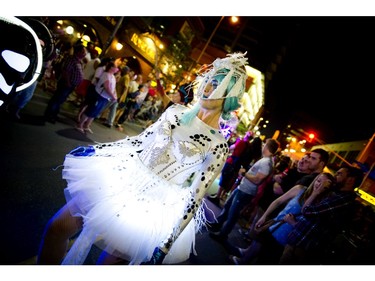 Members of Black Mohawk production group make their way down Bank Street during Glowfair Festival Friday June 17, 2016.