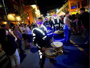 Members of Black Mohawk production group make their way down Bank Street during Glowfair Festival Friday June 17, 2016.