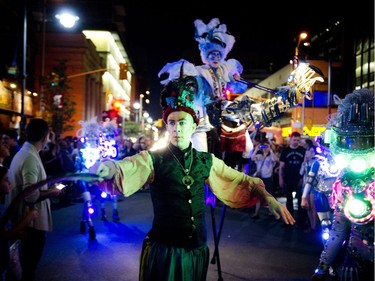 Members of Black Mohawk production group make their way down Bank Street during Glowfair Festival Friday June 17, 2016.