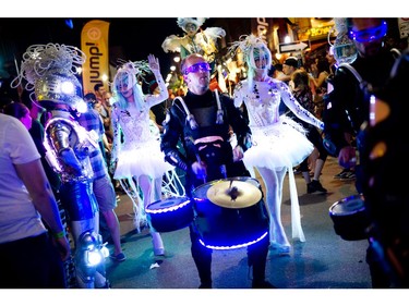 Members of Black Mohawk production group make their way down Bank Street during Glowfair Festival Friday June 17, 2016.