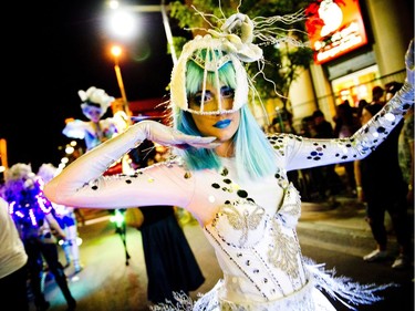 Members of Black Mohawk production group make their way down Bank Street during Glowfair Festival Friday June 17, 2016.