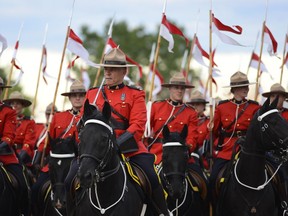 Members of RCMP Musical Ride gets ready for the Sunset ceremony at RCMP Musical Ride Stables on Wednesday, June 22, 2016.