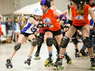 Montreal Rhythm and Bruise jammer Évaëlle Piat gets bumped by Ottawa Junior Roller Derby's Fiona Haugen.