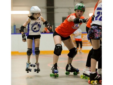 Montreal Rhythm and Bruise jammer, Évaëlle Piat, puts on the breaks behind a blocking Julianna Haugen, 17, of Ottawa Junior Roller Derby.