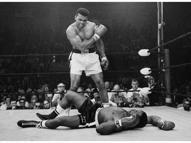 FILE - In this May 25, 1965, file photo, heavyweight champion Muhammad Ali stands over fallen challenger Sonny Liston, shouting and gesturing shortly after dropping Liston with a short hard right to the jaw in the first round of their title fight in Lewiston, Maine. The bout produced one of the strangest finishes in boxing history as well as one of sports' most iconic moments.