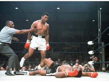 FILE - In this May 25, 1965, file photo, heavyweight champion Muhammad Ali is held back by referee Joe Walcott, left, after Ali knocked out challenger Sonny Liston in the first round of their title fight in Lewiston, Maine.  Ali, the magnificent heavyweight champion whose fast fists and irrepressible personality transcended sports and captivated the world, has died according to a statement released by his family Friday, June 3, 2016. He was 74. (AP Photo/File) ORG XMIT: NY203