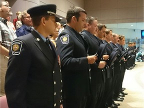 Ottawa Fire Services graduates stand for their graduation ceremony at city hall.