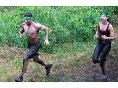 Oleg Vinokurov (L) and Hanna Kosenko make their along the course as the Mud Hero Ottawa 2016 continued on Sunday at Commando Paintball located east of Ottawa.