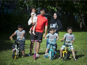 On the bikes, from left, Abdullah, 7, Lyana, 3, (in her dad's arms) Zeid, 5, and Mohamad, 7, with parents Jehad Alsebaee and Nirmeen Alsebai. This Syrian refugee family arrived in Ottawa just before Christmas 2015.