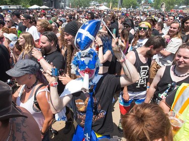 One reveller wears a fleur-de-lis assemble in honour of St Jean Baptiste Day as the annual Amnesia Rockfest invades the village of Montebello in Quebec, about an hour away from Ottawa and Montreal.