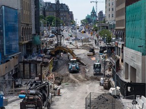 Work to repair the massive sinkhole on Rideau Street continued on Monday, June 20, 2016.