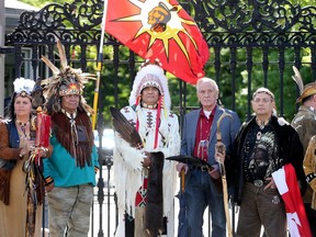 Order of Canada recipient, Douglas Cardinal, an architect and native elder (fourth from right) stood at the gates with other chiefs from  the Confederation of Aboriginal People of Canada.