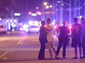 Orlando Police officers direct family members away from a multiple shooting at a nightclub in Orlando, Fla., Sunday, June 12, 2016. A gunman opened fire at a nightclub in central Florida, and multiple people have been wounded, police said Sunday.