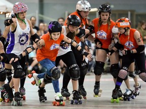 Ottawa Junior Roller Derby jammer, Kaitlin Golab "KneeOn Ninja", (in black star helmet) pushes through Montreal Rhythm and Bruise's Oriane Rullier, 00, during a bout at Brewer Arena Saturday, May 7, 2016. (Darren Brown) Assignment