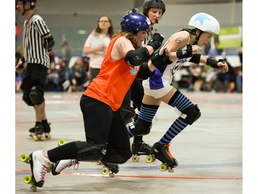 Ottawa Junior Roller Derby Sharky Dwyer, 111, falls while Montreal Rhythm and Bruise's Louise Rouan-Leroux, 6, drives past.