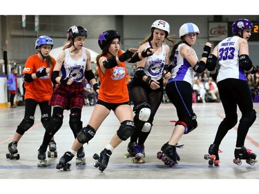Ottawa Junior Roller Derby's Avery Jacole, centre, escapes a line of Montreal Rhythm and Bruise blockers.