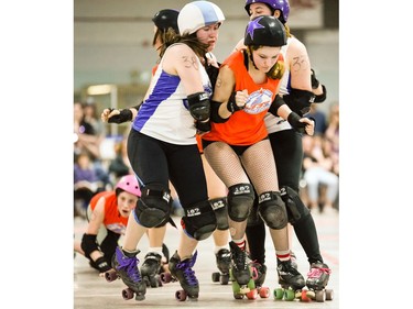 Ottawa Junior Roller Derby's Bailey Griffiths, 13, squeezes past the block of Montreal Rhythm and Bruise's Ariane Théroux, 38, and Marie-Pier Beauchamp, 333.