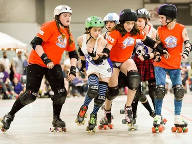 Ottawa Junior Roller Derby's Finley Briggs-Webb, 333, escapes the block of Montreal's Louise Rouan-Leroux, 6, while OJRD's Kaitlin Golab, right, and Katherine Marty Pimm, 16, look on.