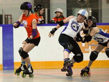 Ottawa Junior Roller Derby's Fiona Haugen, 22, gets by a blocking attempt Montreal Rhythm and Bruise players.