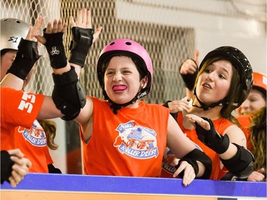 Ottawa Junior Roller Derby's Skye Ferguson, hi-fives her teammates after their roller derby bout against Montreal Rhythm and Bruise at Brewer Arena.