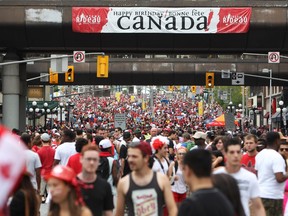 OTTAWA, ONTARIO: July 1, 2013 - People walk on Rideau Street during Canada Day festivities on July 1, 2013 in Ottawa.