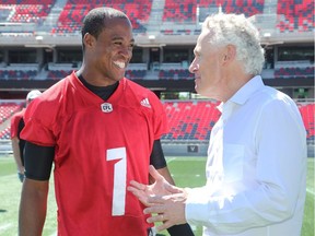 Ottawa Redblacks quarterback, Henry Burris (left), gets a laugh from UFC Vice President and General Manager, Tom Wright. UFC athletes and the Ottawa Redblacks share mixed martial arts and CFL football skills after the Redblacks' practice at TD Place Wednesday.