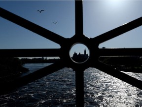 Parliament Hill is framed in the railing of the Portage Bridge in Gatineau, Quebec, on Thursday, May 14, 2015.