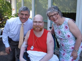 Peter Marshall, centre, with his father, George, and mother, Janet, in the garden at Maycourt Hospice.