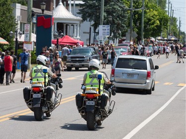 Police patrol along Rue Notre-Dame as the annual Amnesia Rockfest invades the village of Montebello in Quebec, about an hour away from Ottawa and Montreal.