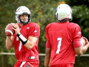 Quarterback Trevor Harris trains with starting QB, Henry Burris, right.