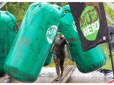Rebekah Wilson makes her way through an obstacle as the Mud Hero Ottawa 2016 continued on Sunday at Commando Paintball located east of Ottawa.